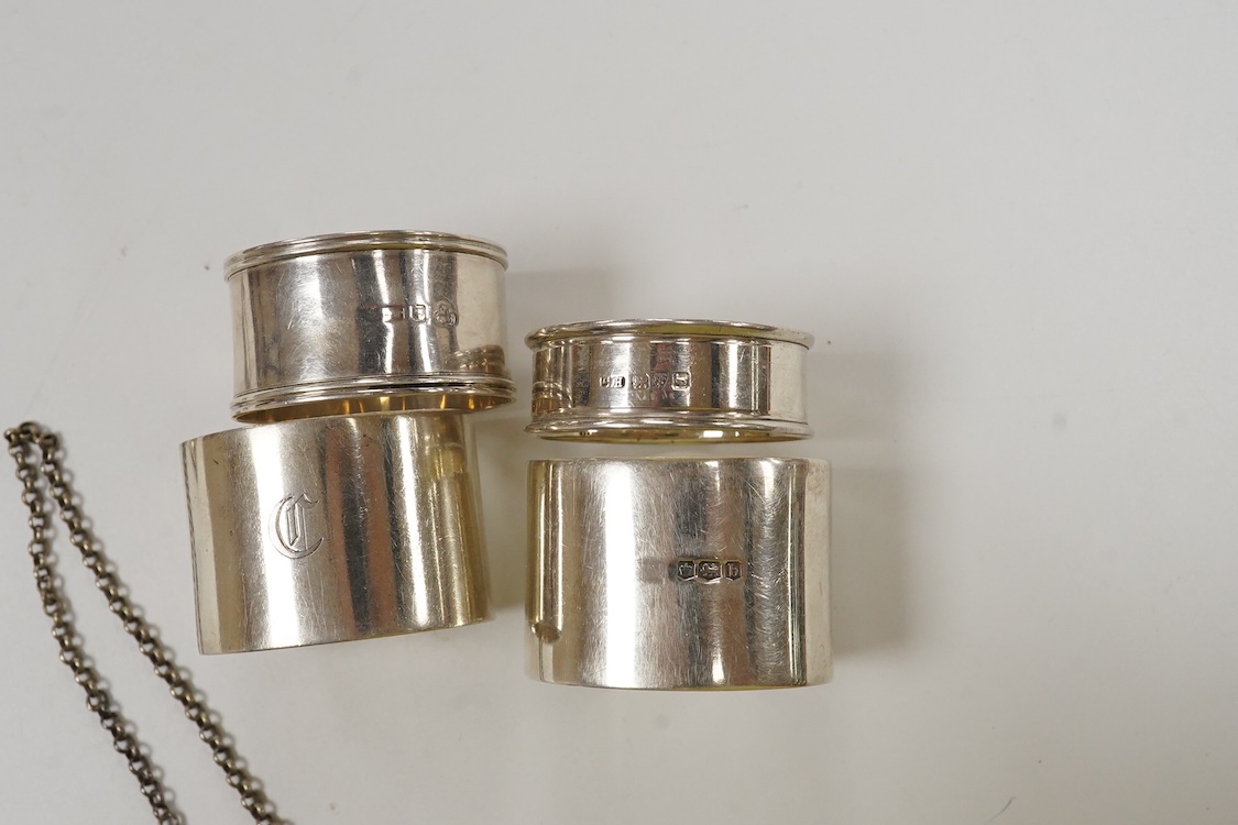Four silver napkin rings including a pair, Sheffield, 1919, together with two George III silver wine labels, Claret, maker probably Abstinando King and Port, maker James Phipps I.
